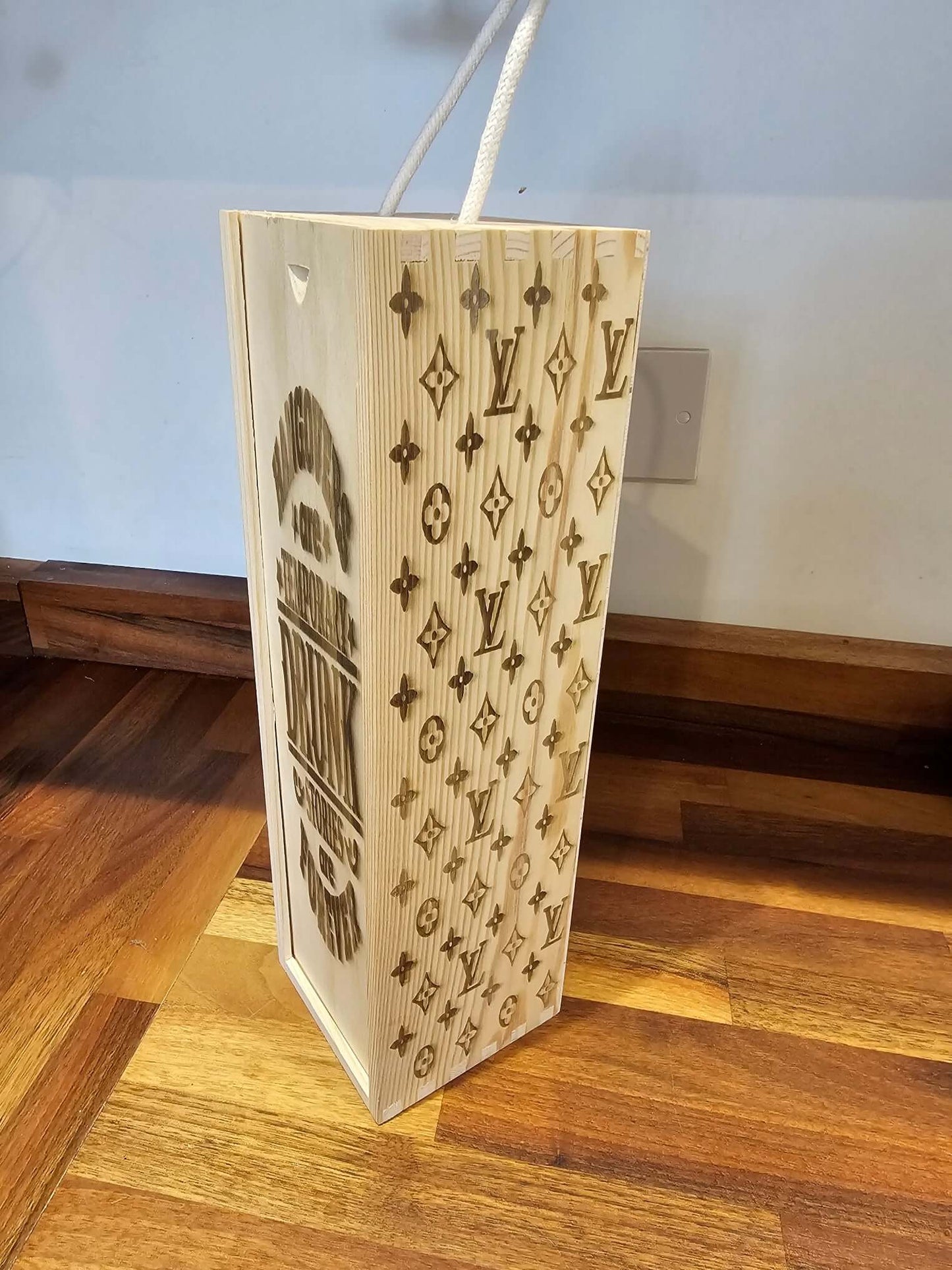 Engraved Wooden Wine Bottle Gift Box with Louis Vuitton pattern displayed on a wooden floor.