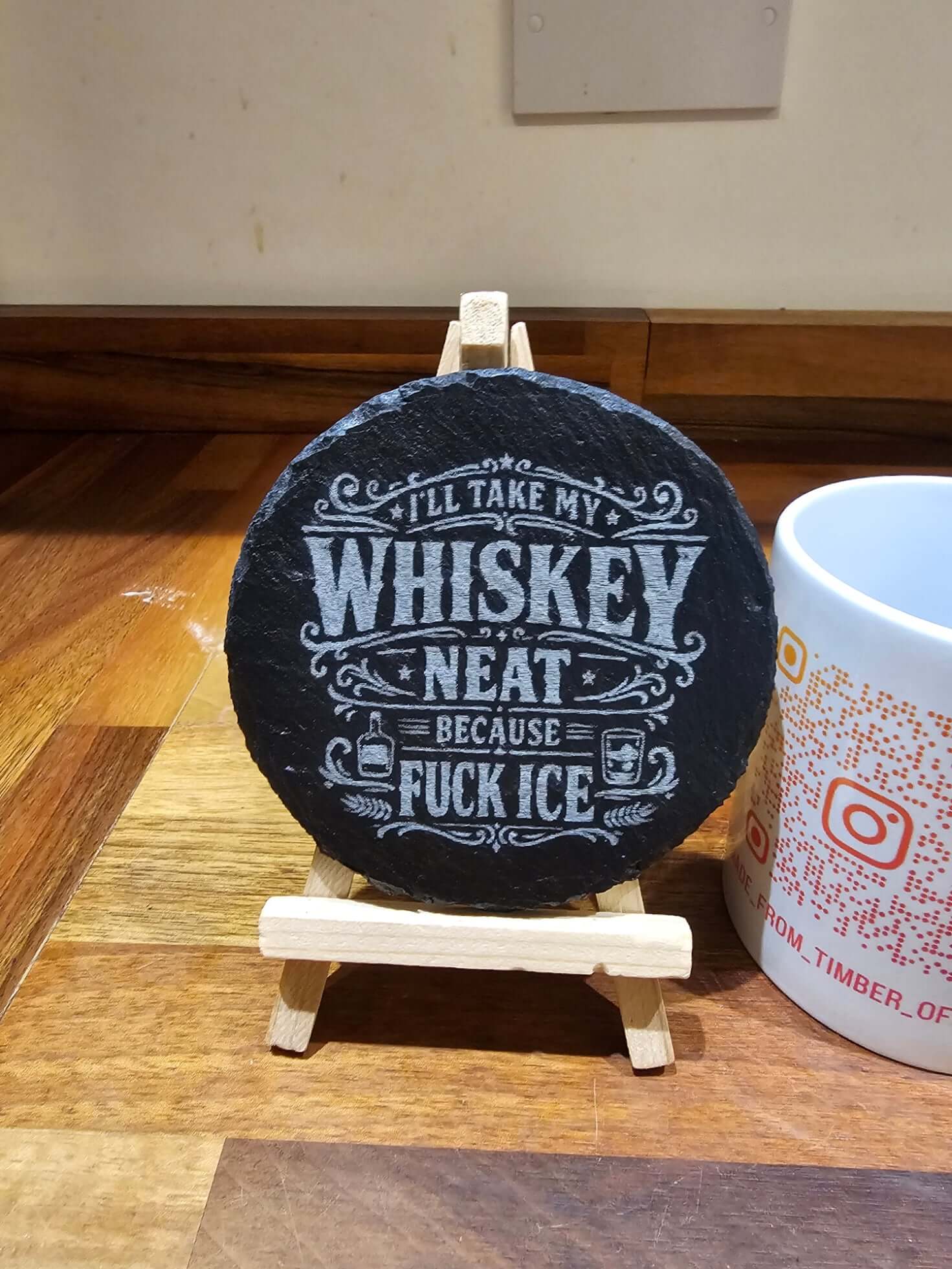 Slate Coasters Engraved Coaster showing humorous engraving: 'I'll take my whiskey neat because fuck ice' on natural slate.