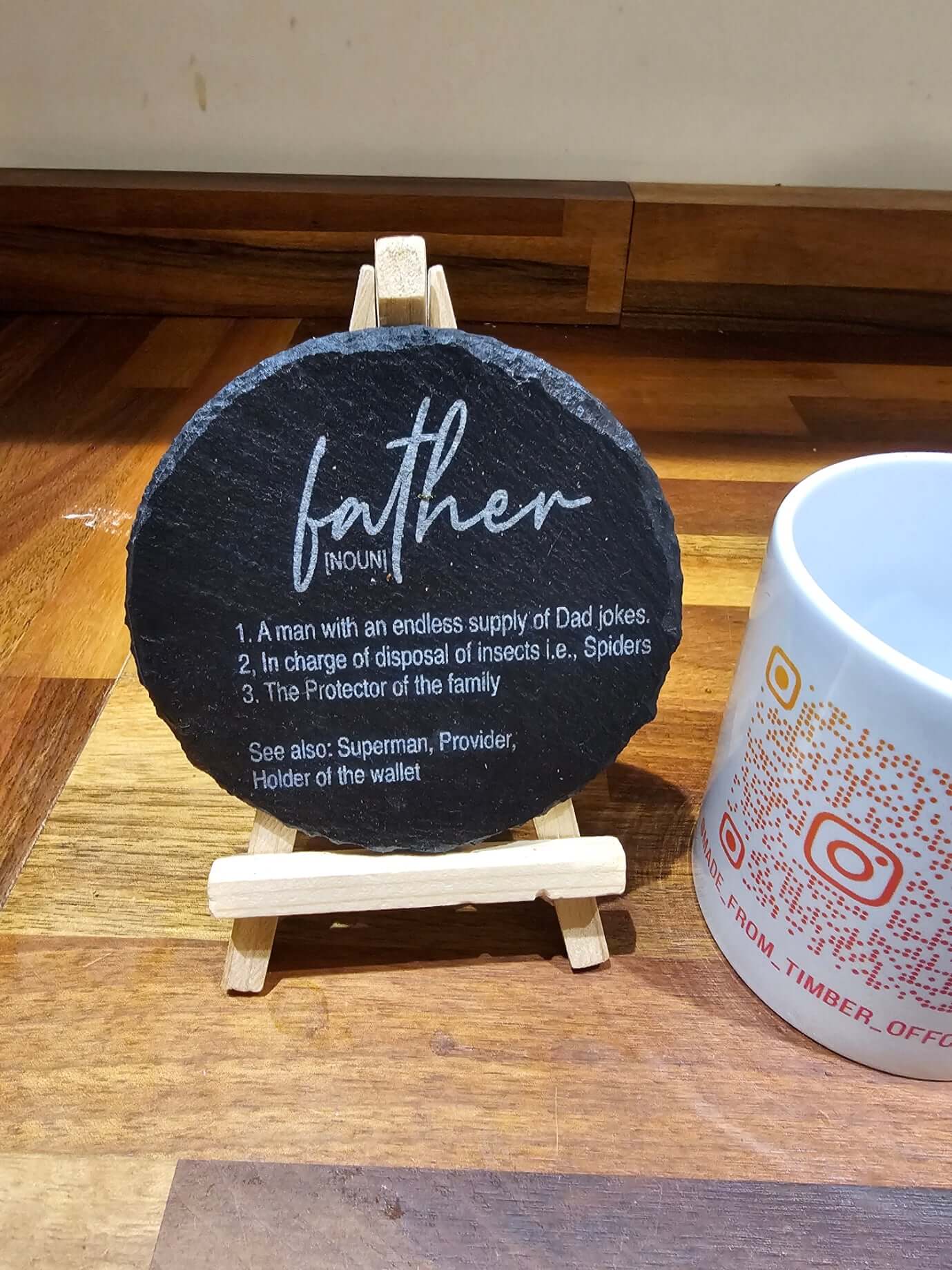 Slate Coasters Engraved featuring humorous definition of 'Father – noun' on a natural slate coaster.