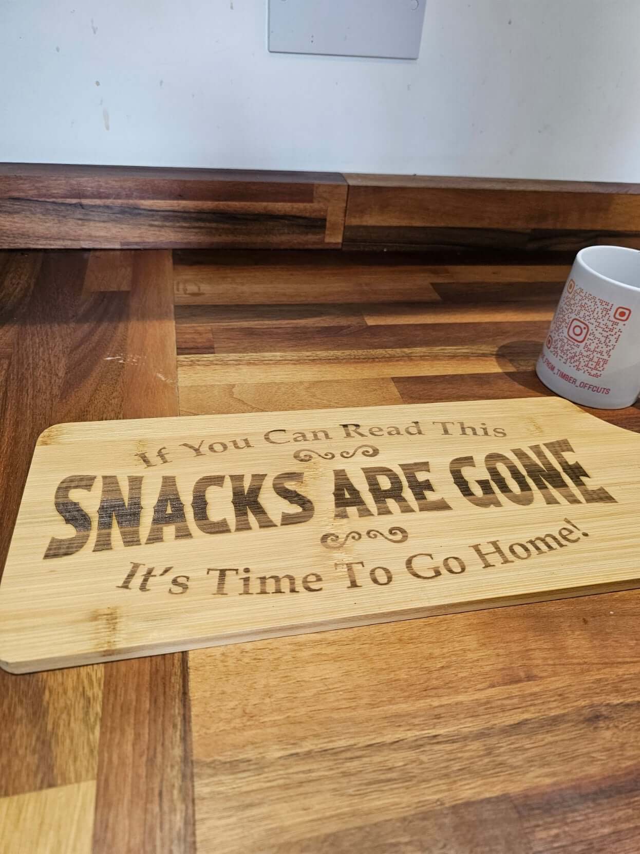 Funny Engraved Serving Board showcasing the quote "Snacks Are Gone, It's Time To Go Home" on a bamboo surface.