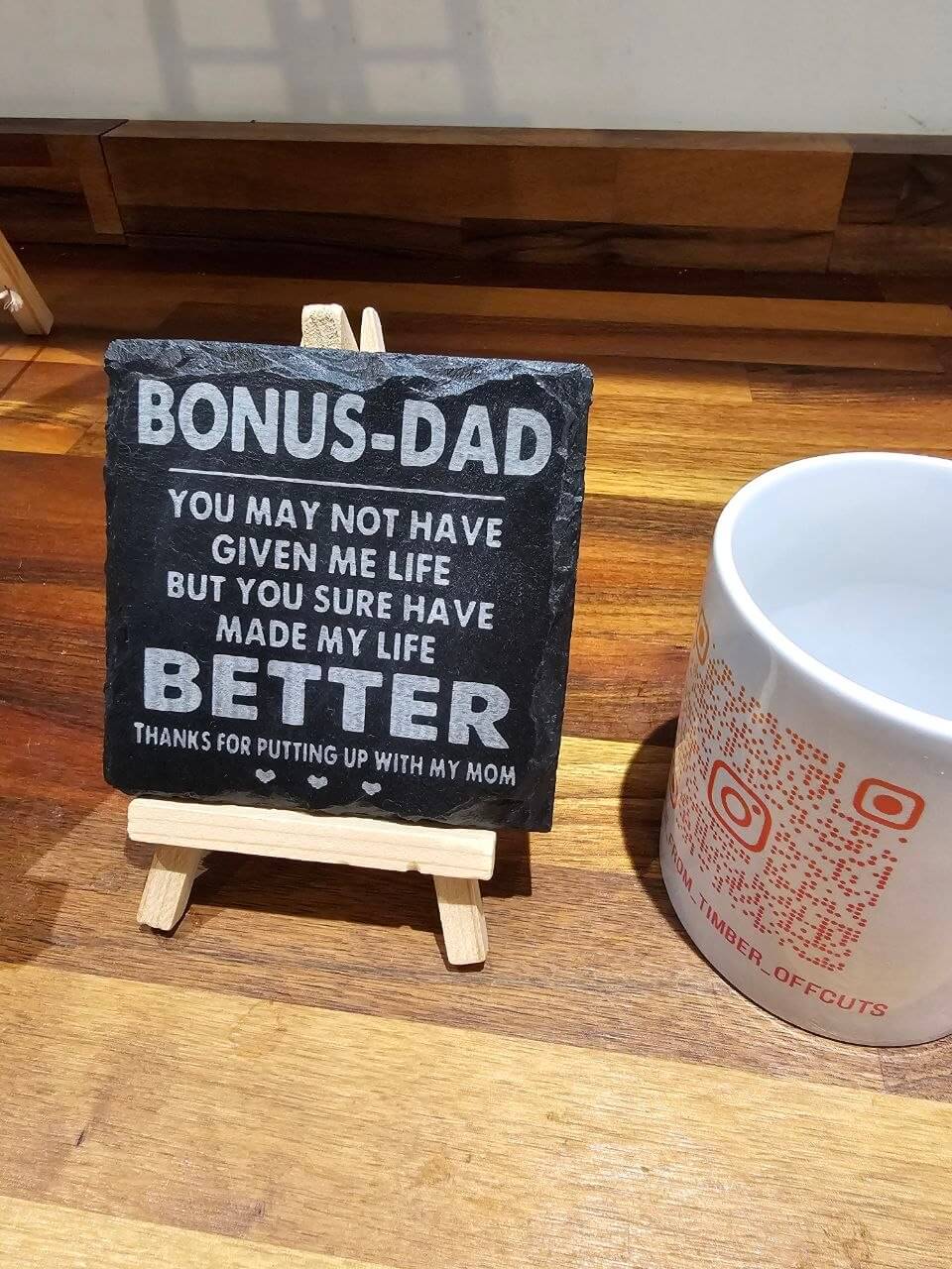 Slate coaster reading 'Bonus Dad' with appreciation message on display, perfect for gifting.