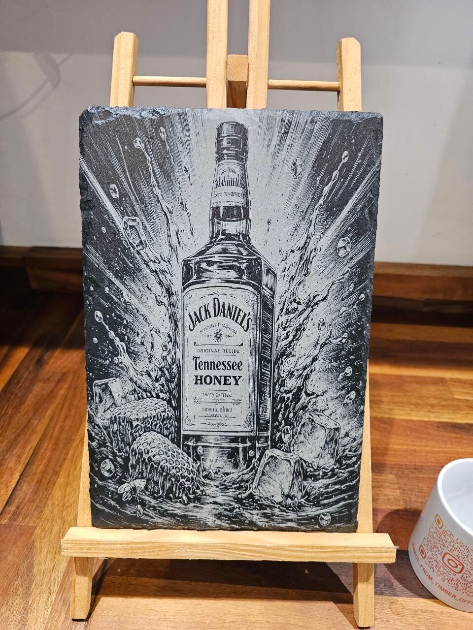 Slate Plaque Whiskey Bottle – engraved art featuring Jack Daniel's Tennessee Honey with splash effects on display.