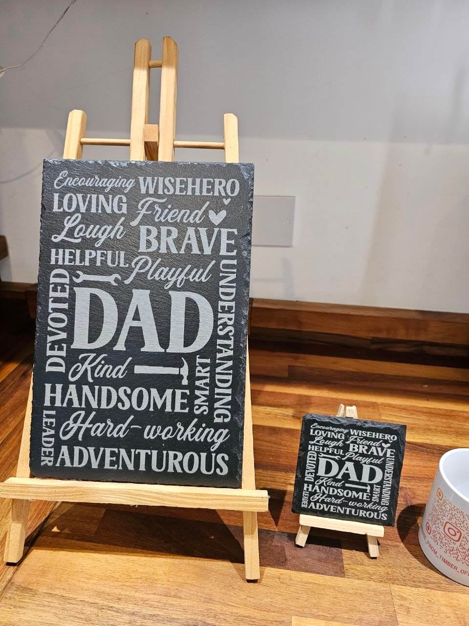 Slate plaque Dad with meaningful words like Strong, Loving, Brave displayed on an easel for Father’s Day.