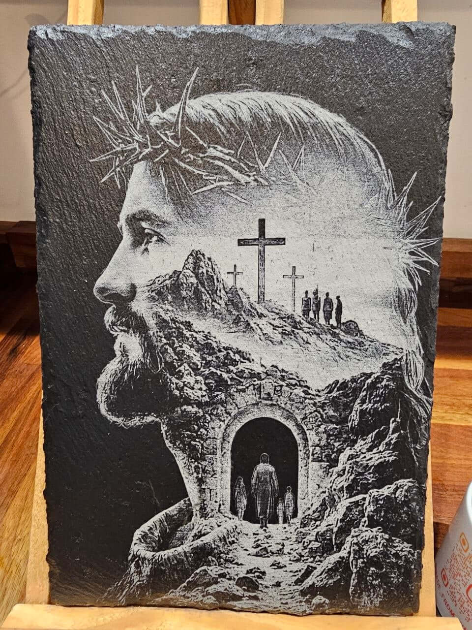 Slate plaque featuring an artistic portrayal of Jesus with a crown of thorns and a scenic background.