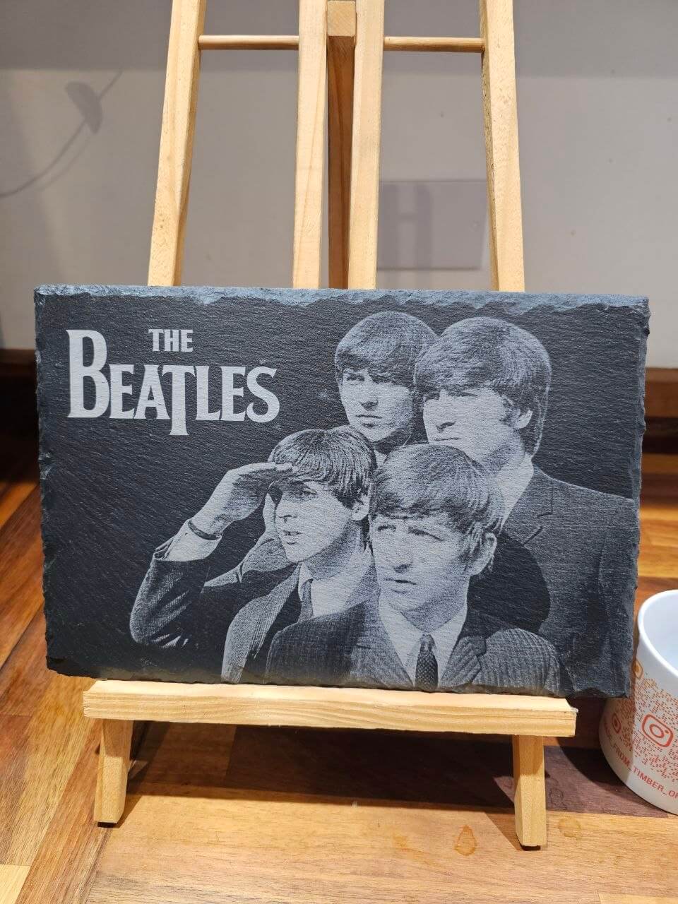 Slate plaque featuring engraved portraits of The Beatles, ideal wall art for music fans.
