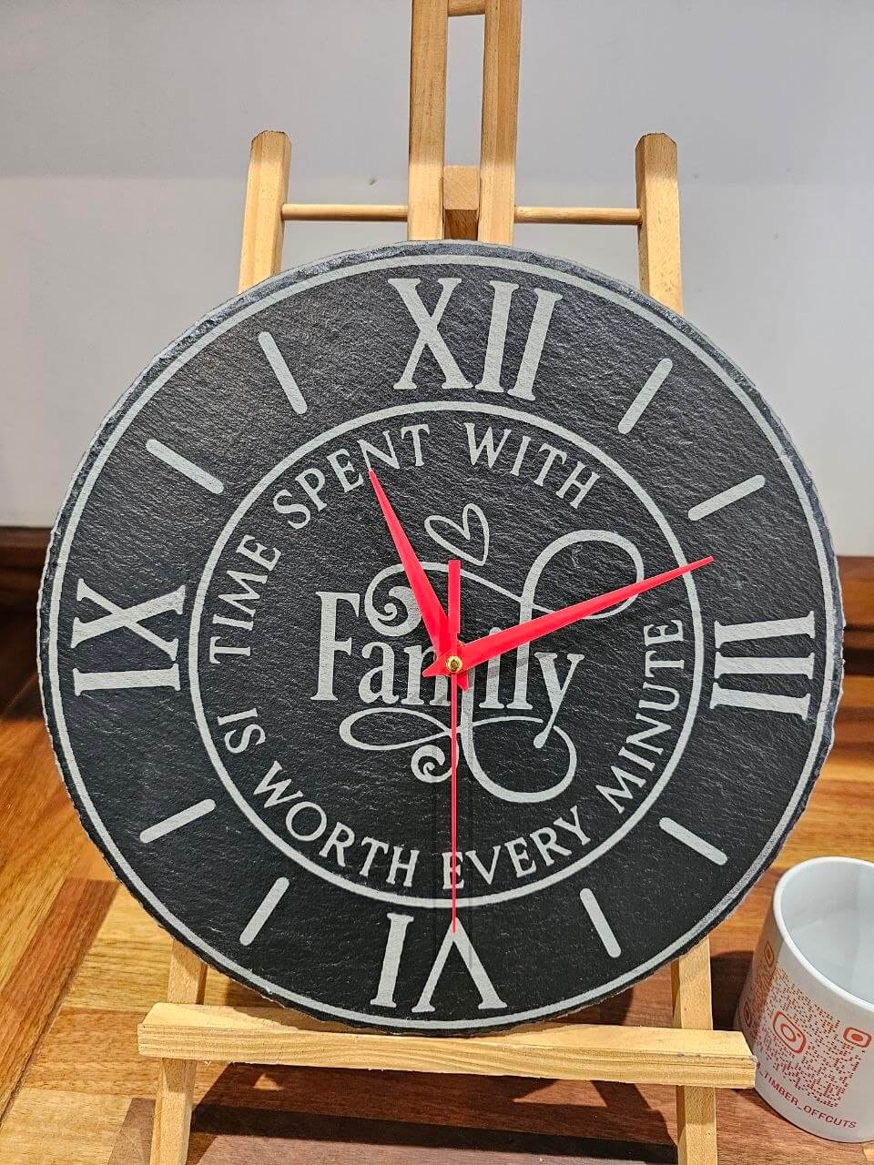 Family Time Engraved Round Slate Clock – 30cm – Laser Engraved Family on display with red hands and roman numerals.