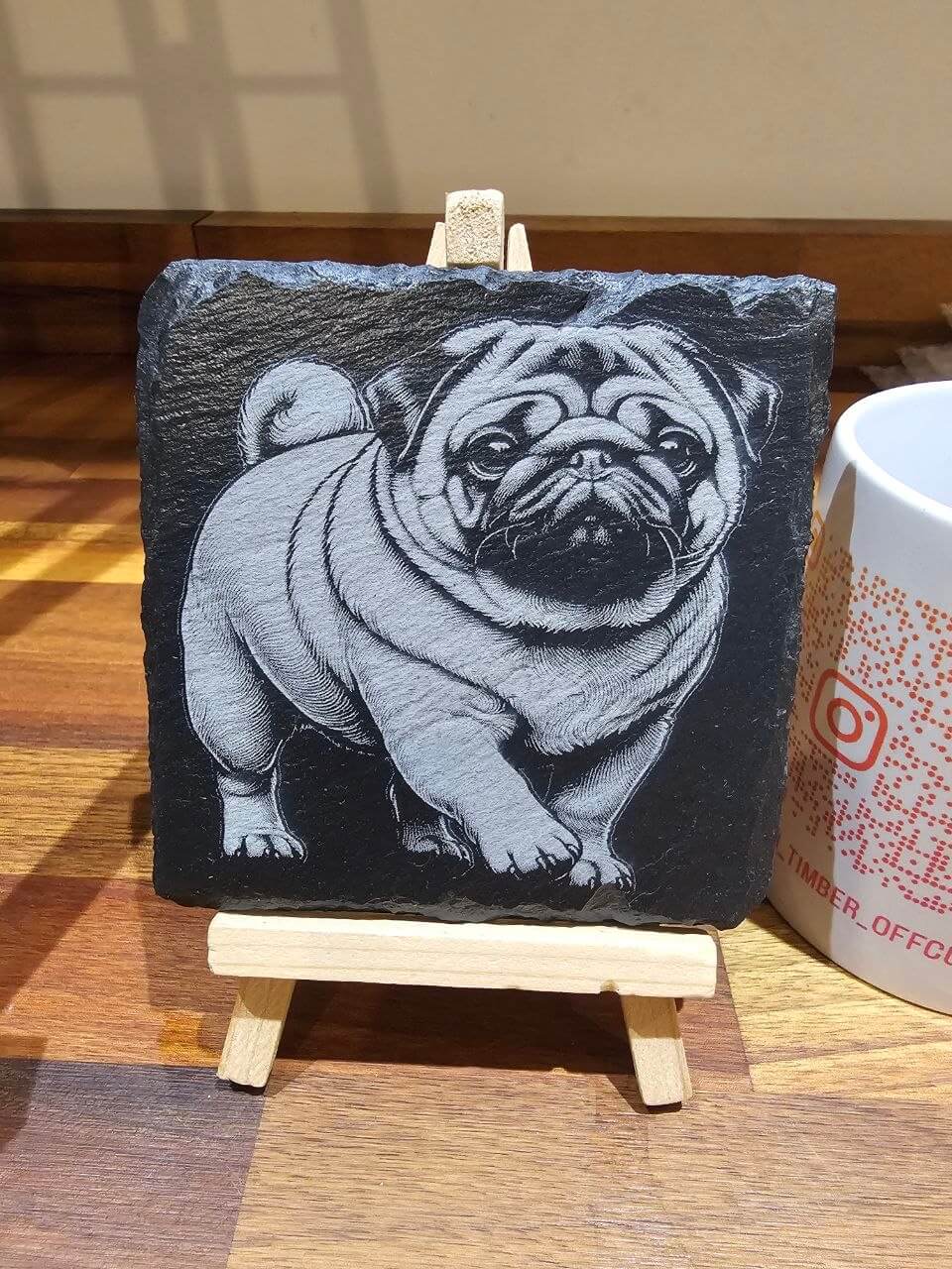 Pug edition Premium Custom Laser-Engraved Slate Coaster 10cm displayed on small easel.